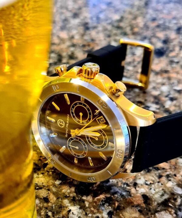 A gold watch sitting on top of a table.