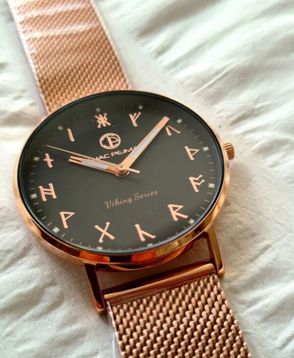 A watch is shown on the bed.