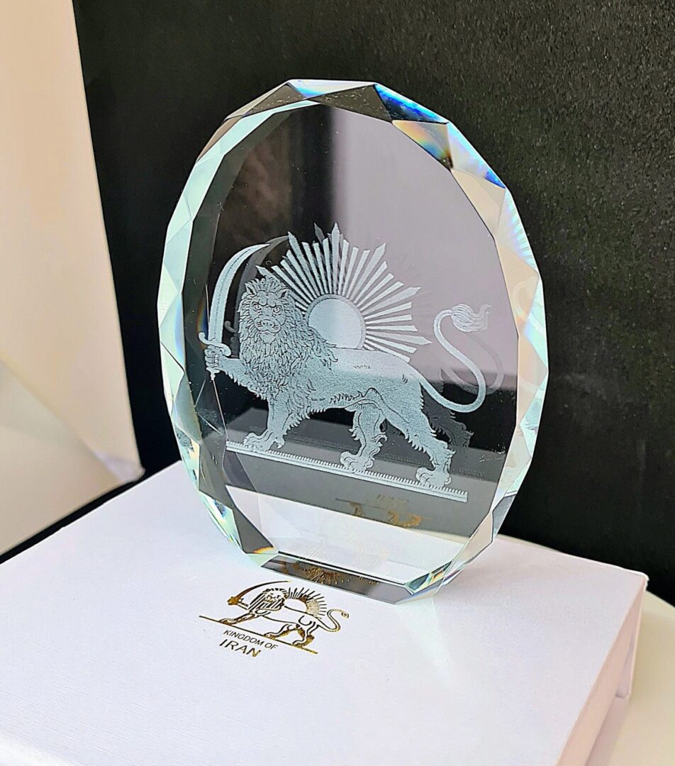A glass plaque with an image of a lion on it.