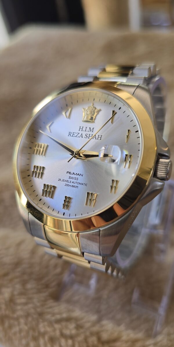A gold and silver watch with roman numerals.