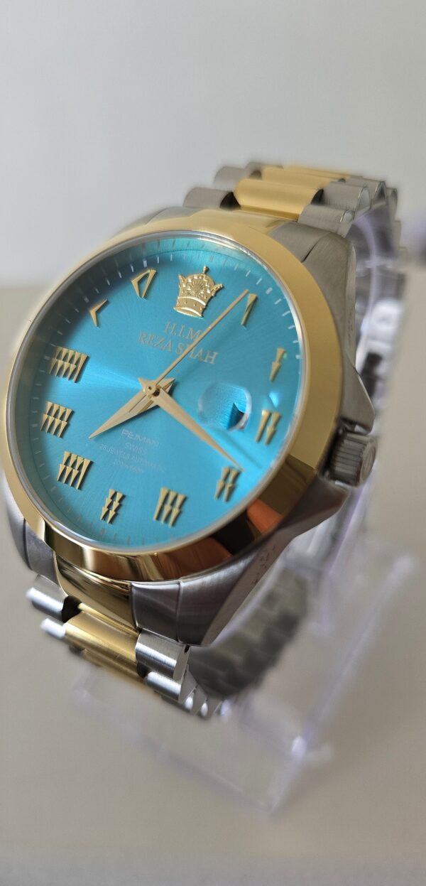A blue and gold watch sitting on top of a table.