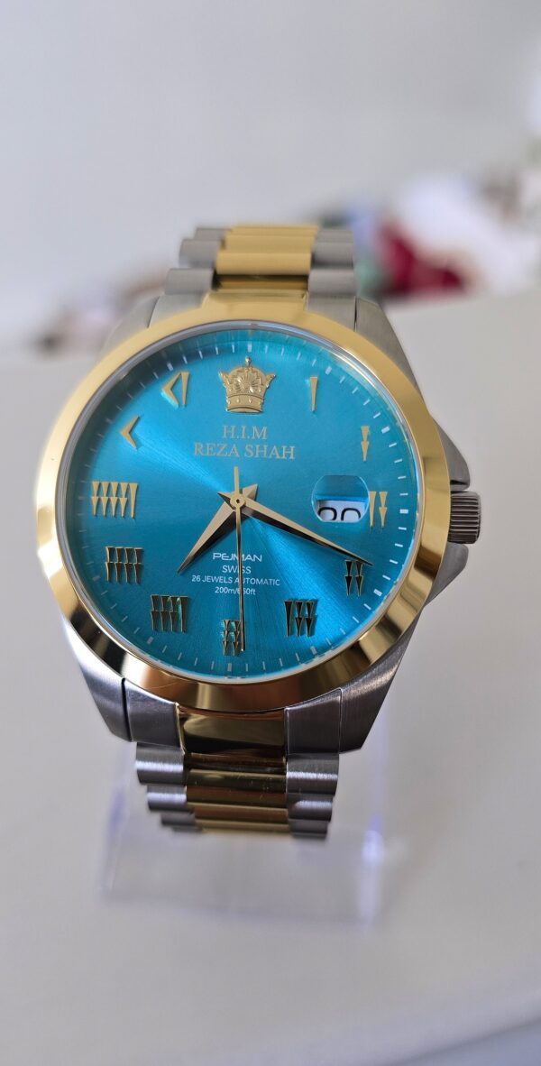 A blue and gold watch on a silver bracelet.
