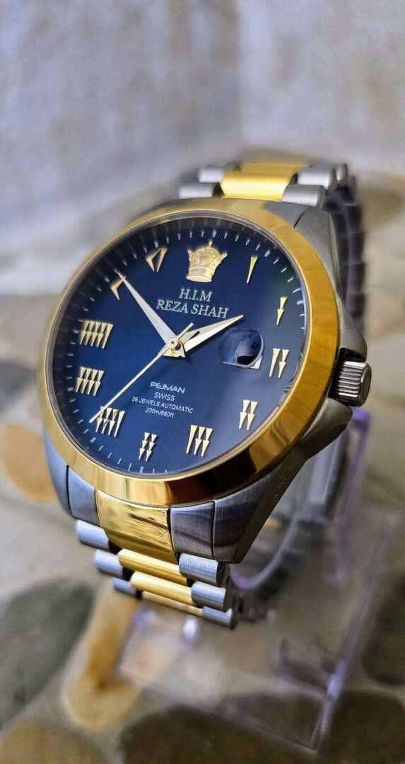 A gold and silver watch with roman numerals on it.