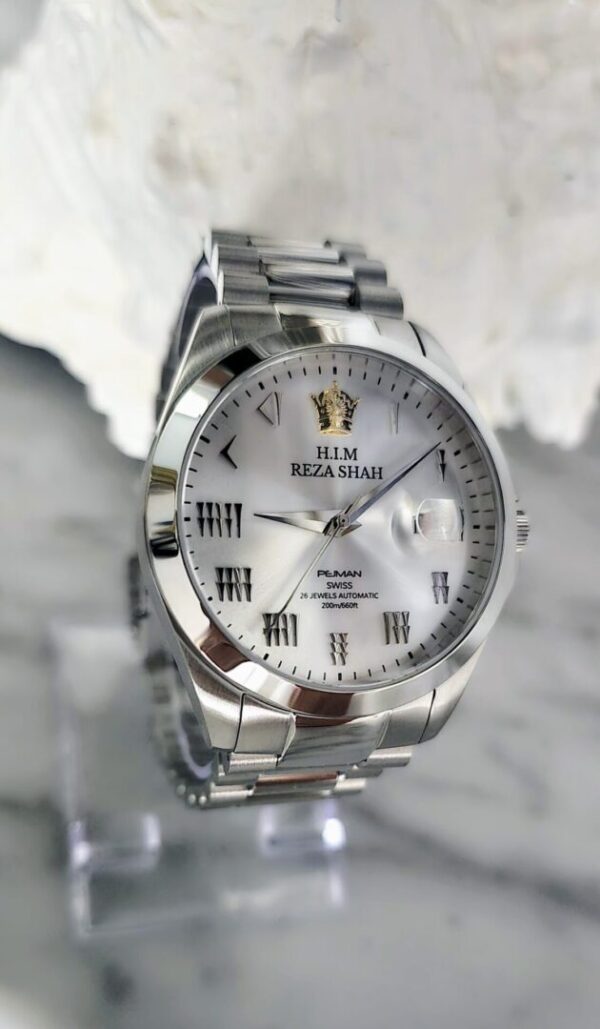 A silver watch with roman numerals on it.