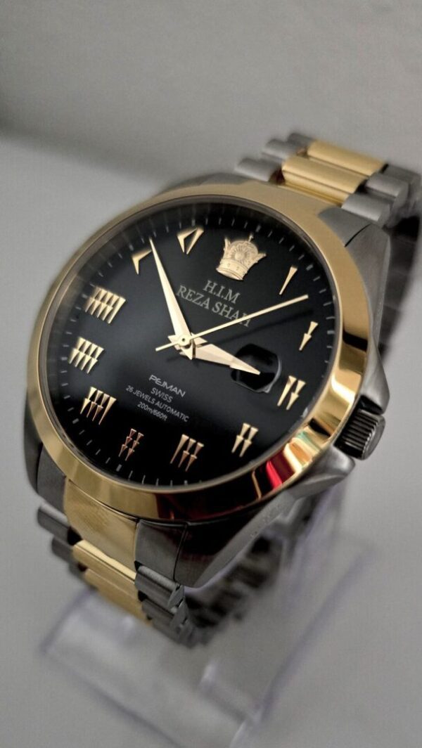 A black and gold watch is on the table