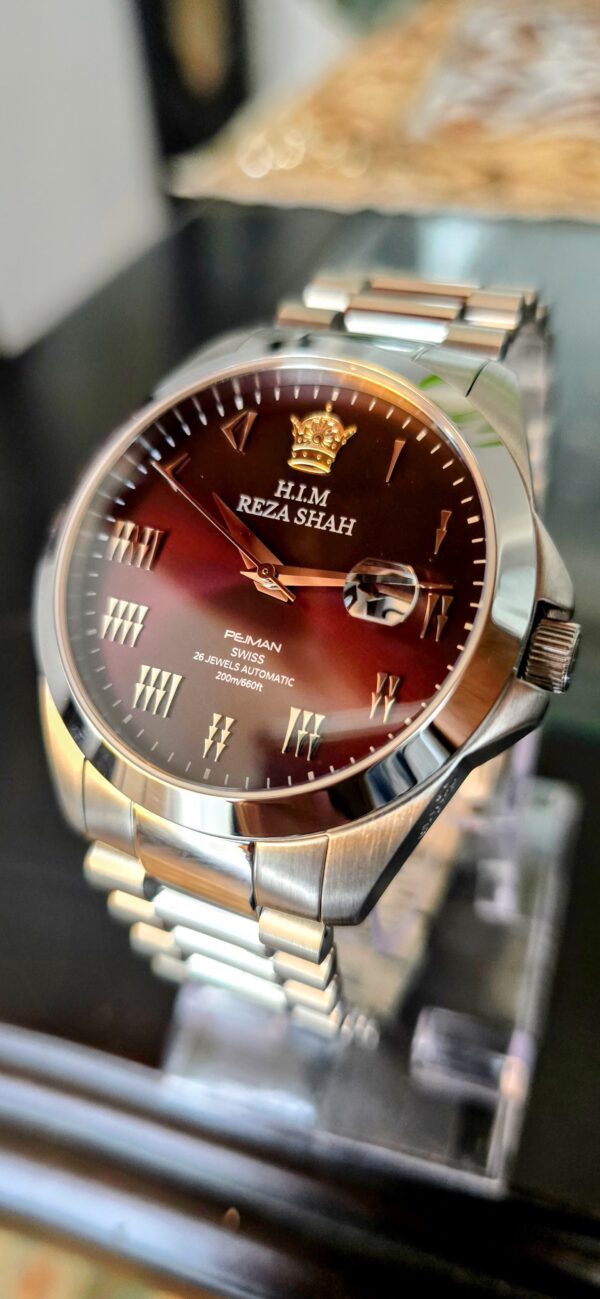 A watch is shown with the hands and crown on it.