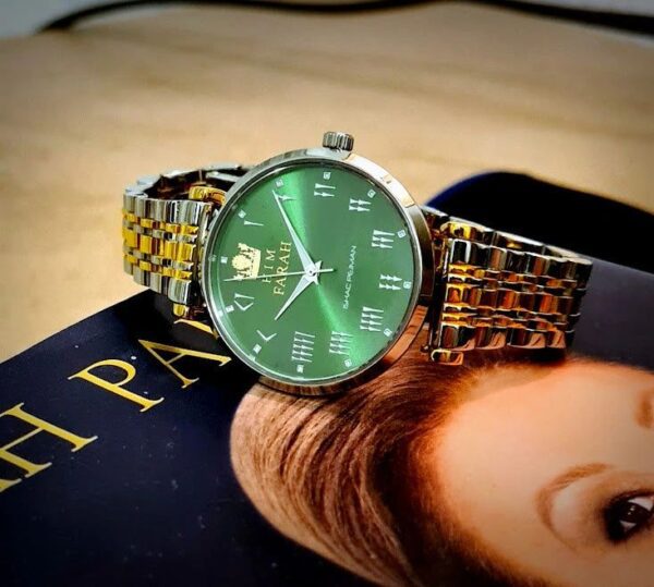 A person wearing a watch on top of a book.