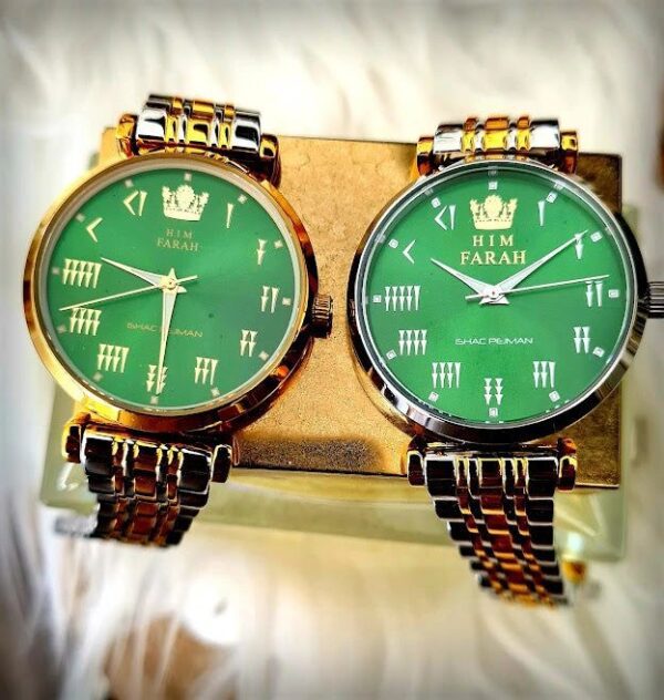 Two watches are sitting side by side on a table.
