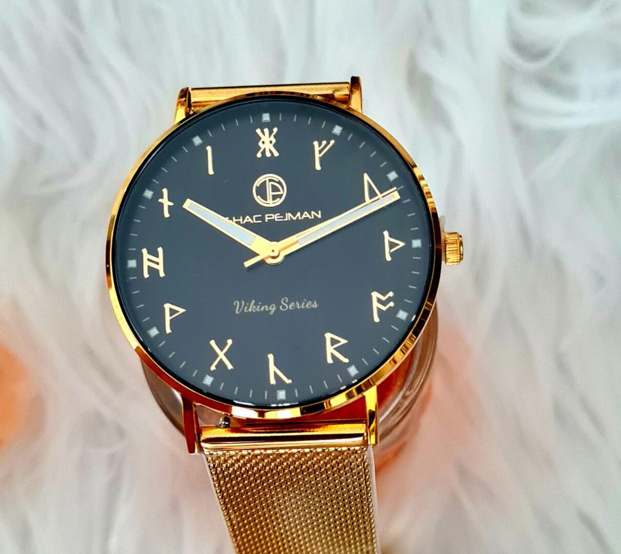 A gold watch with roman numerals on it.