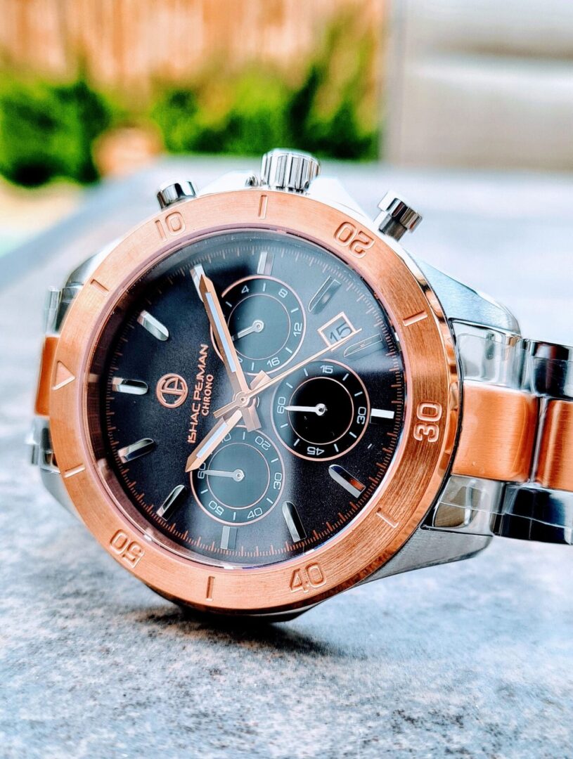 A watch is sitting on the ground outside.