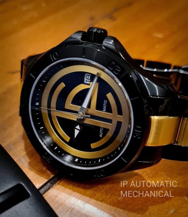 A watch sitting on top of a wooden table.