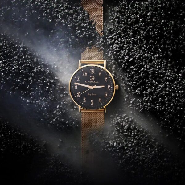A watch is shown in the middle of some dirt.