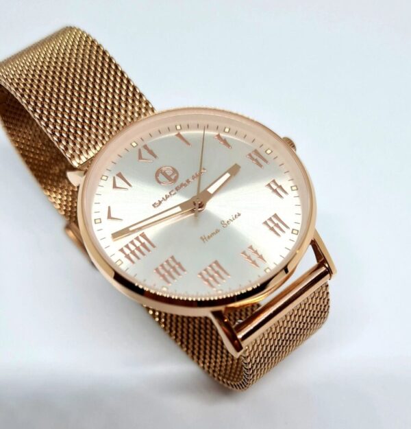 A gold watch with roman numerals on it.