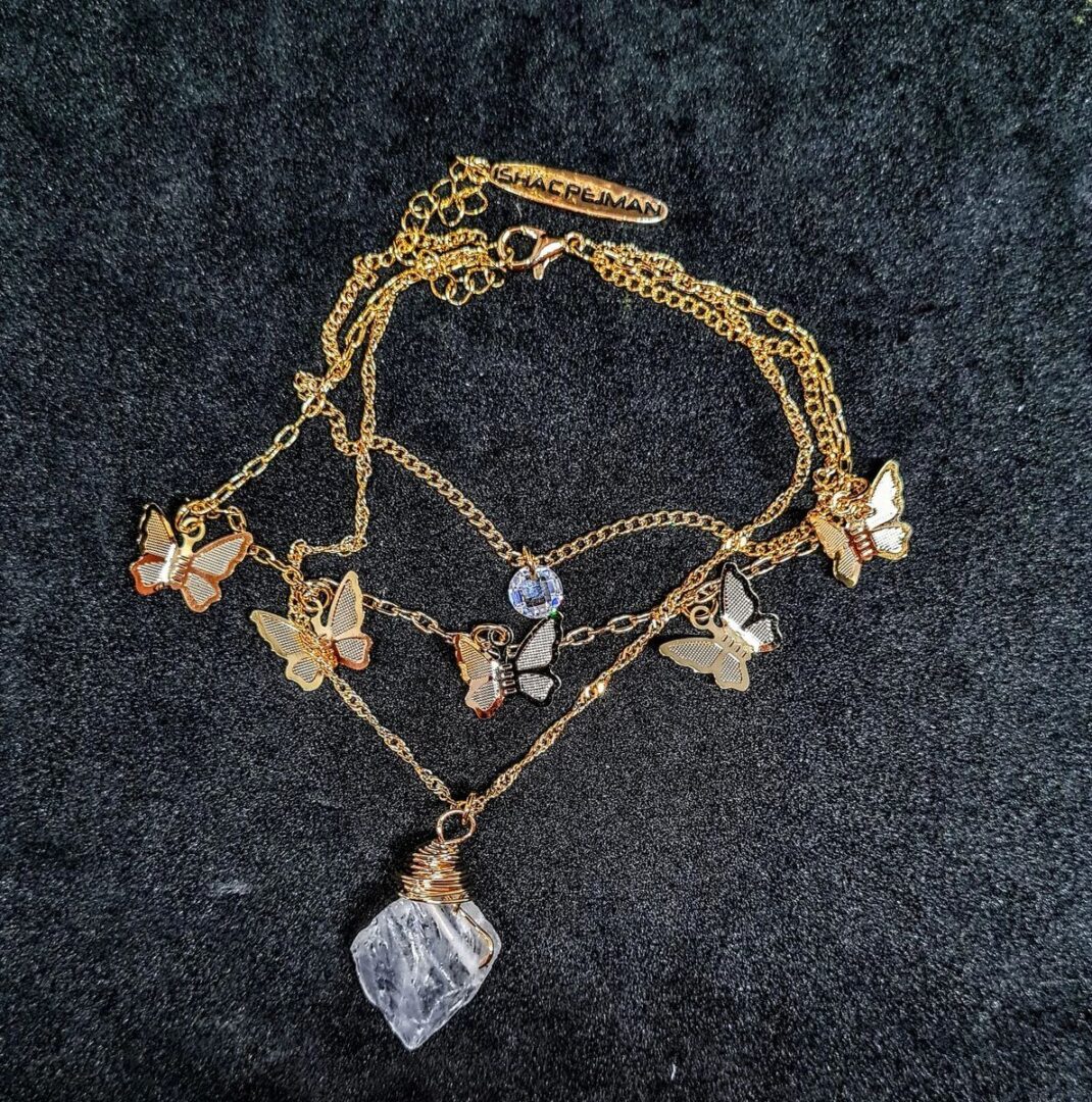 A necklace with gold chains and charms on it.