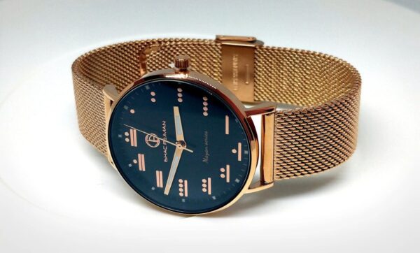 A gold watch with a black face and a rose gold strap.