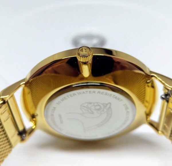 A gold watch with the back of it