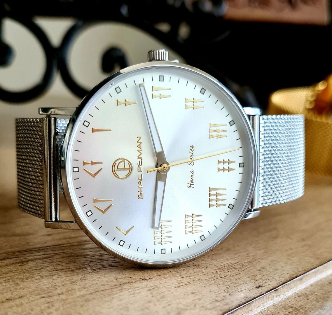A watch sitting on top of a wooden table.