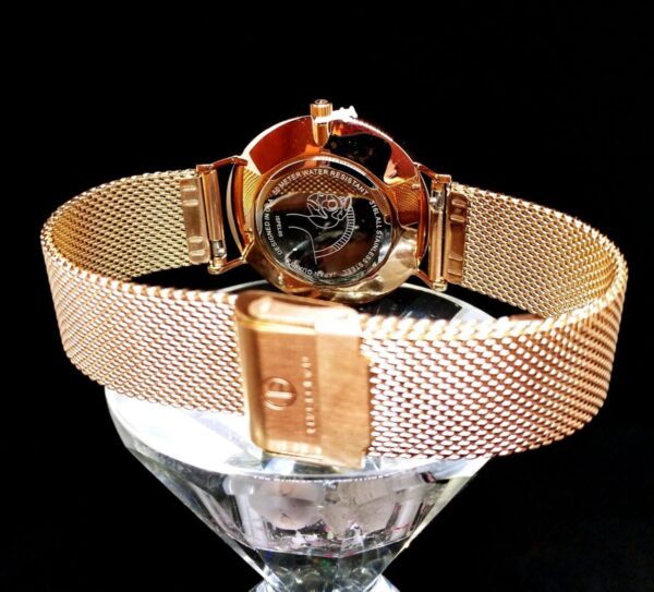 A watch is shown on top of a glass.