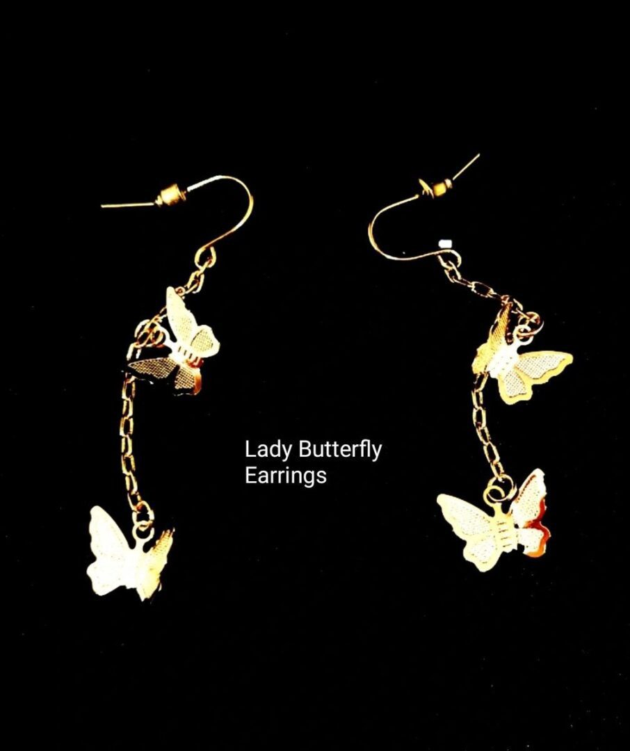 A pair of earrings with butterflies hanging from them.