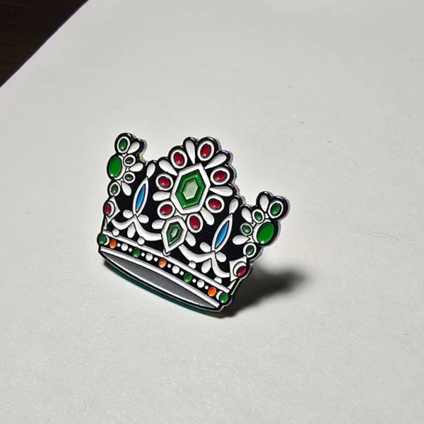 A white and black crown with colored jewels on it.