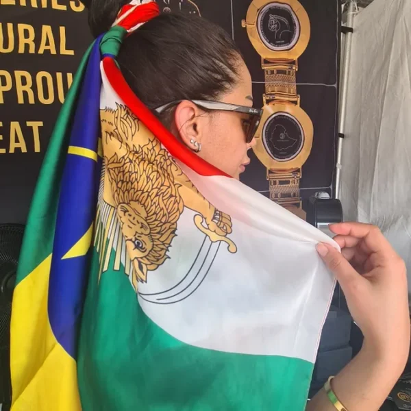 A woman with sunglasses and a flag on her head.