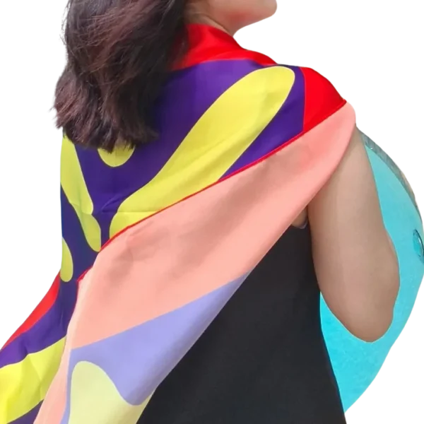 A woman wearing a colorful scarf is standing up.