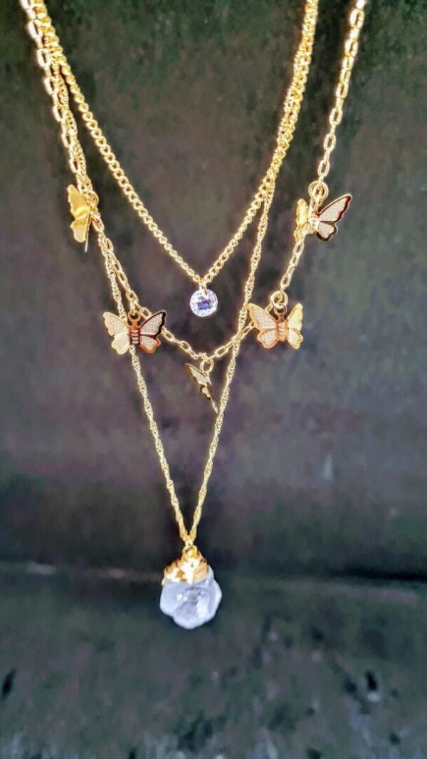 A necklace with multiple chains and charms.