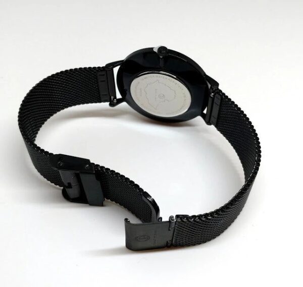 A black watch with a metal strap on top of it.