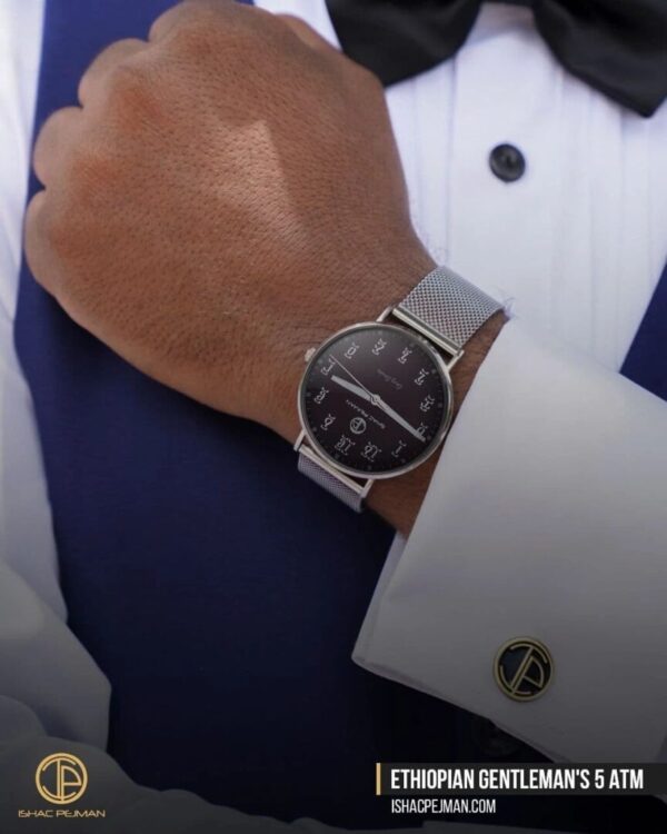 A man wearing a watch and white shirt
