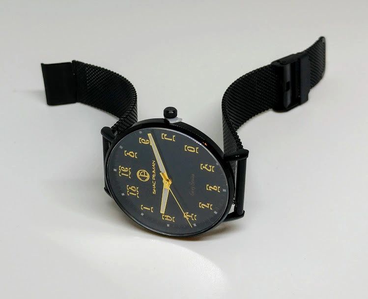 A black watch with yellow numbers on it.