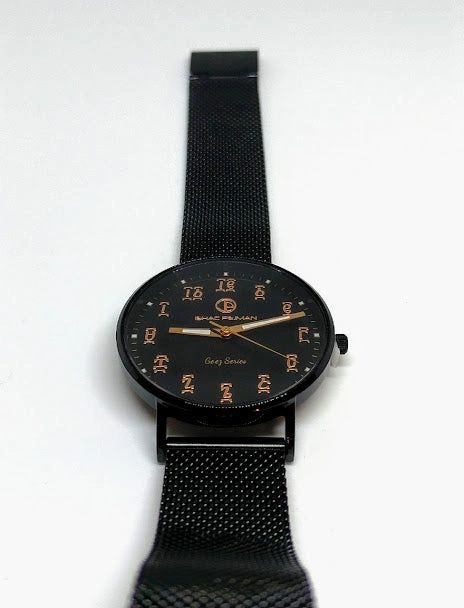 A black watch with orange numbers on it
