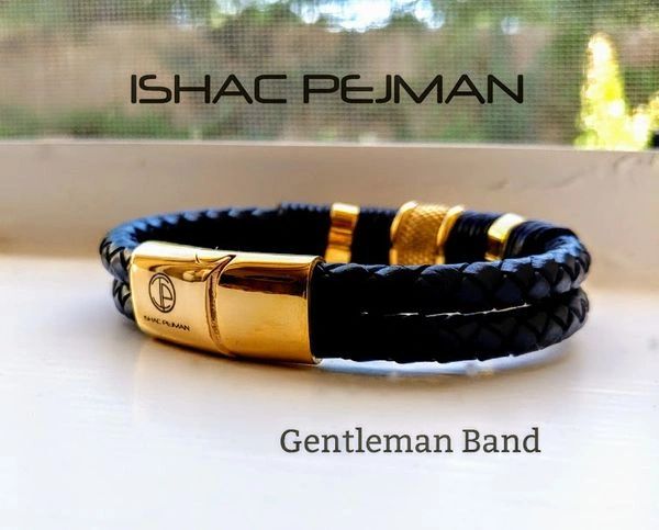 A black and gold bracelet with a picture of a man.