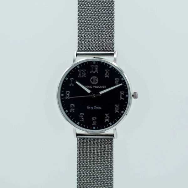 A watch with a black face and silver mesh strap.