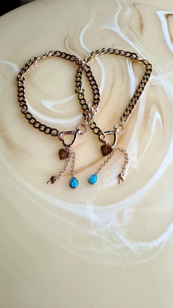 A pair of necklaces with turquoise beads and heart charms.