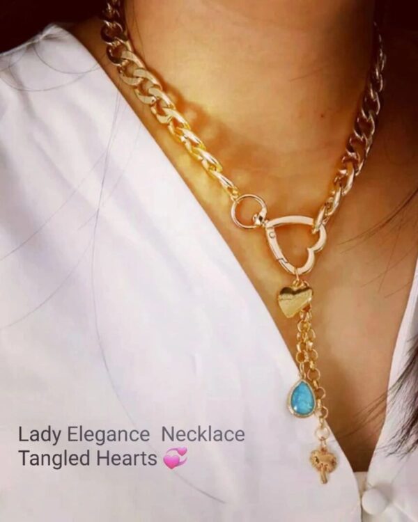 A woman wearing a necklace with hearts and charms.