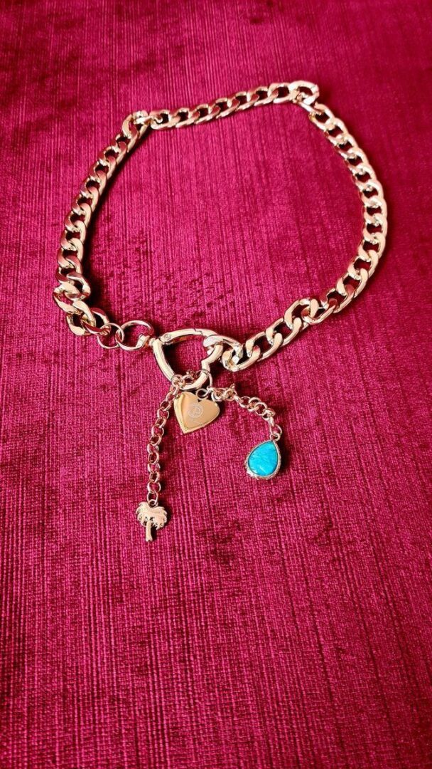 A close up of a necklace on a pink background
